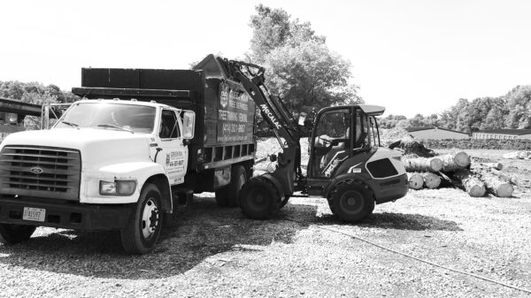 Mecalac wheel loader loading material into work truck