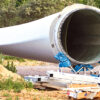 Retired wind turbine blade awaiting recycling at a storage site.