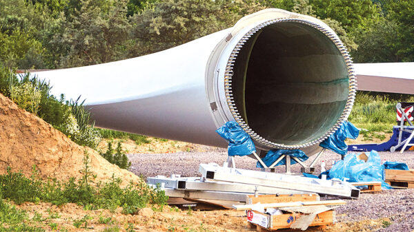 Retired wind turbine blade awaiting recycling at a storage site.