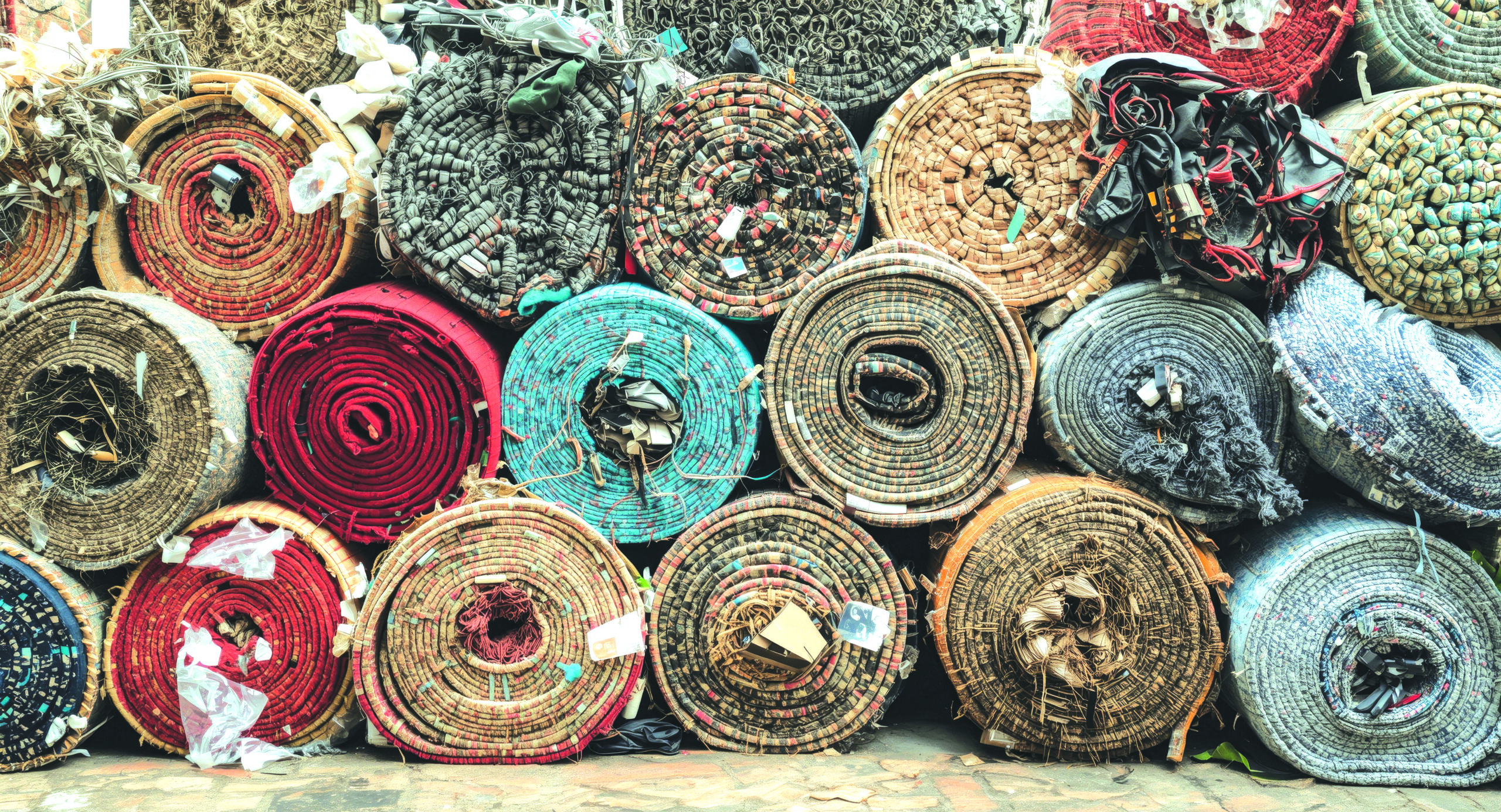 Stacks of rolled recyclable materials and industrial scrap prepared for recycling