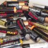 Collection of used household batteries including AA and AAA alkaline batteries for recycling or disposal