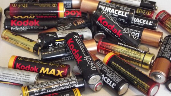 Collection of used household batteries including AA and AAA alkaline batteries for recycling or disposal