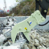 Astec hydraulic concrete pulverizer attachment processing reinforced concrete at a demolition site