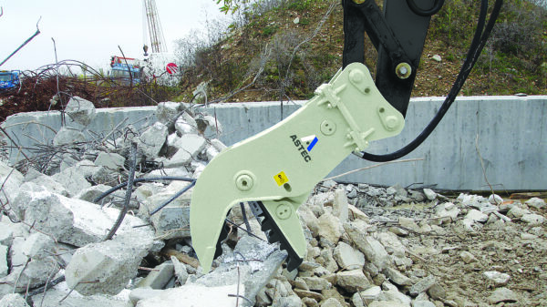 Astec hydraulic concrete pulverizer attachment processing reinforced concrete at a demolition site
