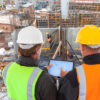 Construction workers reviewing C&D recycling operations at a demolition site