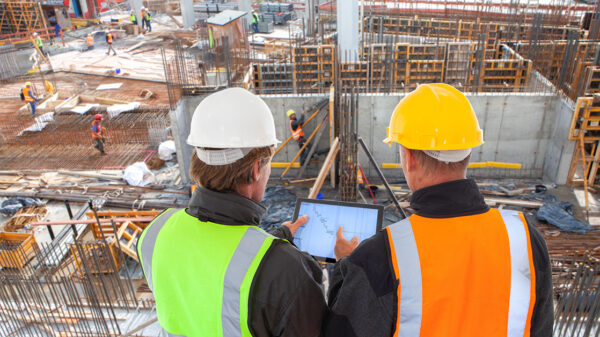 Construction workers reviewing C&D recycling operations at a demolition site