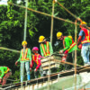 Construction workers building concrete infrastructure at an active job site.