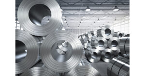 Steel coils stored in a manufacturing facility representing steel production, processing and industrial supply chains