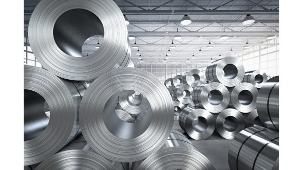 Steel coils stored in a manufacturing facility representing steel production, processing and industrial supply chains
