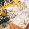 Excavator sorting construction and demolition debris for recycling and material recovery
