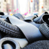 Used tires stacked for recycling and processing into recovered rubber materials.