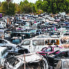Salvage yard with totaled vehicles as auto repair costs rise