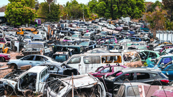 Salvage yard with totaled vehicles as auto repair costs rise