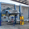 Vehicle on lift with automotive fluid removal equipment