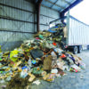 Waste being unloaded from a transfer trailer at a recycling facility